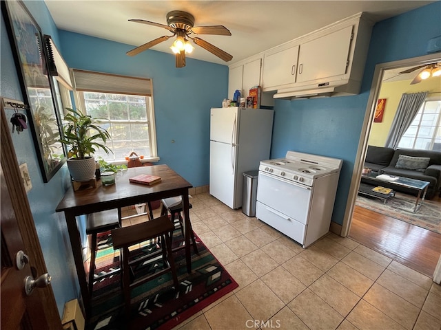 kitchen with white appliances, ceiling fan, light hardwood / wood-style flooring, and white cabinets