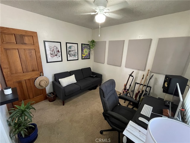 home office with a textured ceiling, carpet flooring, and ceiling fan