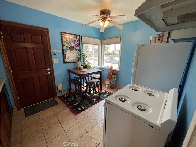 laundry room with ceiling fan, light tile patterned floors, and washer / dryer