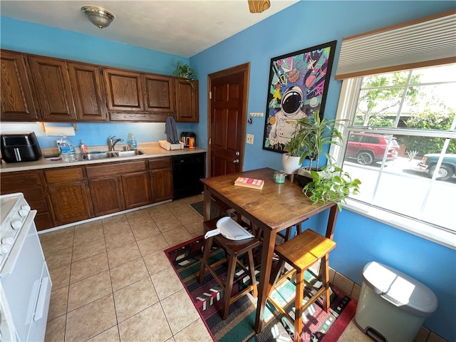 kitchen featuring light tile patterned floors, black dishwasher, sink, and electric range