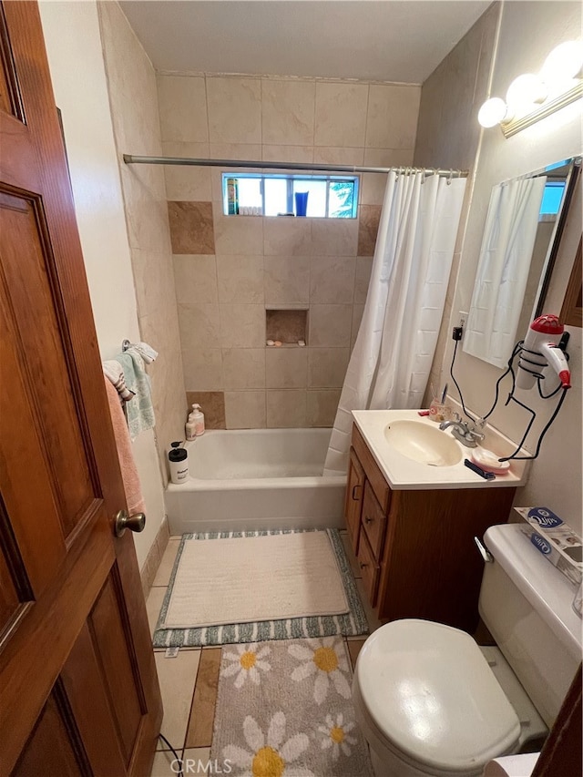 full bathroom featuring tile patterned flooring, vanity, toilet, and shower / bath combo with shower curtain