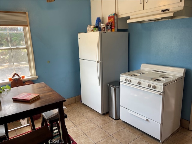 kitchen featuring white appliances and light tile patterned floors