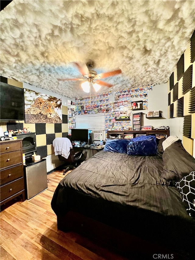 bedroom featuring wood-type flooring and ceiling fan