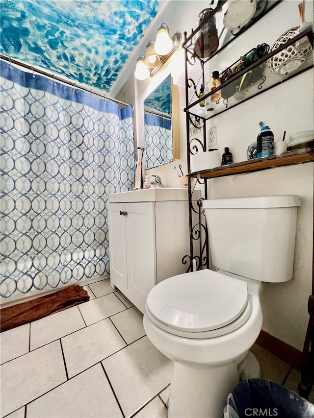 bathroom featuring tile patterned floors, walk in shower, vanity, and toilet