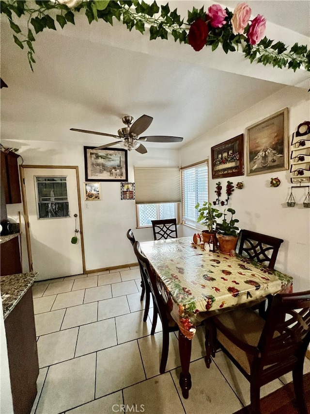 tiled dining room featuring ceiling fan