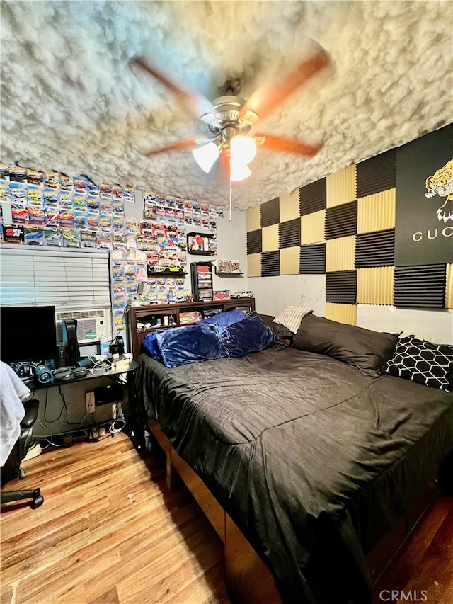 bedroom with ceiling fan and hardwood / wood-style floors