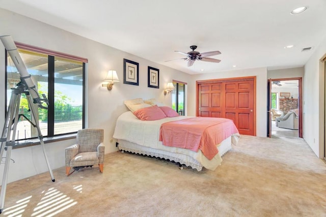 carpeted bedroom featuring access to exterior, ceiling fan, and a closet