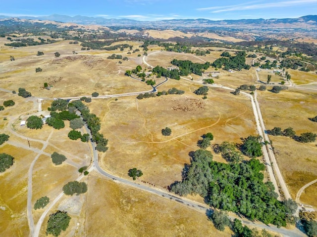 drone / aerial view with a mountain view and a rural view