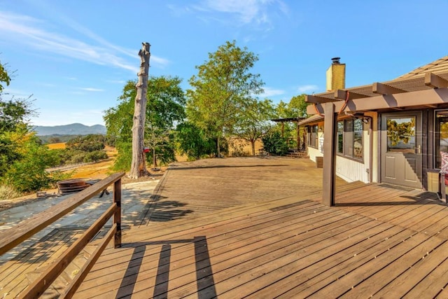 wooden deck featuring a mountain view