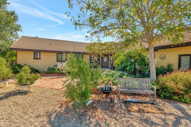 back of house featuring a fire pit