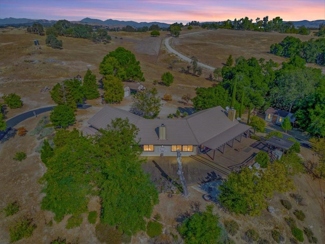 aerial view at dusk featuring a mountain view