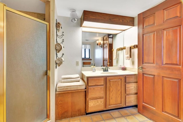 bathroom with tile patterned floors, vanity, and a shower with shower door