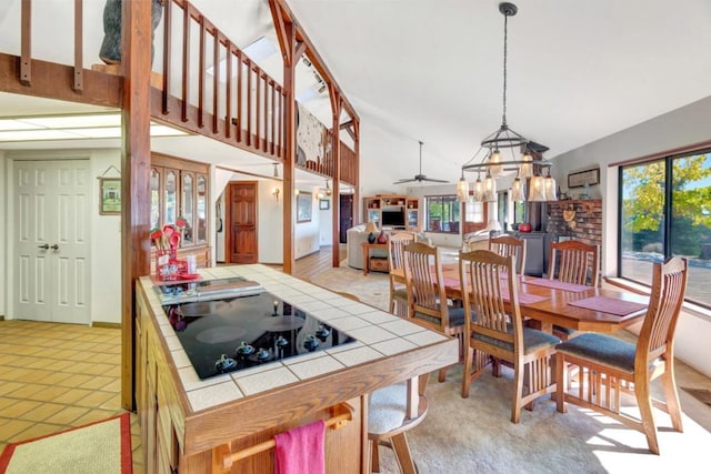 kitchen with tile countertops, plenty of natural light, and black electric cooktop