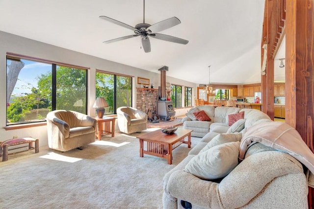 carpeted living room with ceiling fan with notable chandelier, a healthy amount of sunlight, and a wood stove