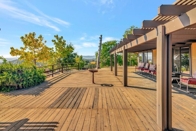 wooden deck with a mountain view and a pergola