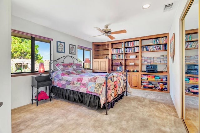 bedroom with ceiling fan and light colored carpet