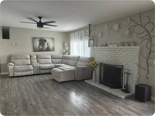 living room with ceiling fan, a brick fireplace, and hardwood / wood-style flooring