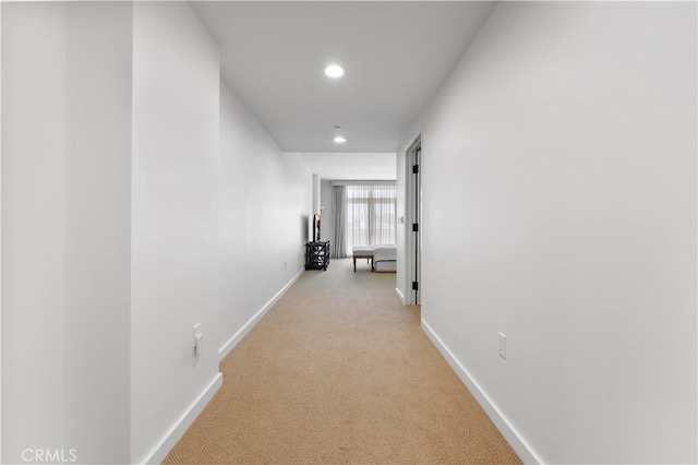 hallway featuring light carpet