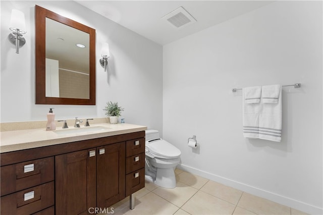 bathroom with tile patterned flooring, vanity, and toilet