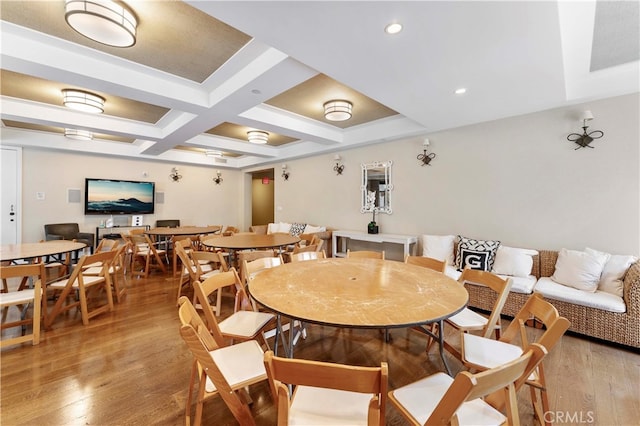 dining area with coffered ceiling, beamed ceiling, and light wood-type flooring