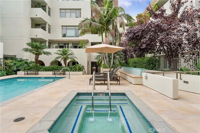 view of pool with a community hot tub and a patio area