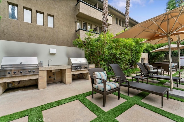 view of patio / terrace featuring area for grilling and a balcony