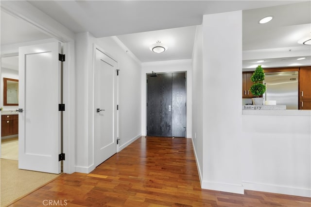 corridor with wood-type flooring