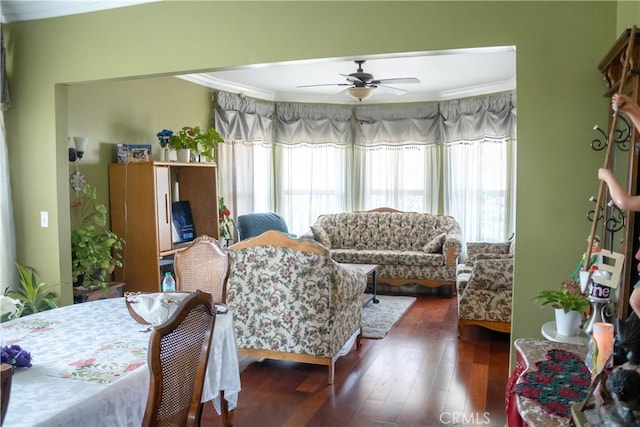 living room featuring ornamental molding, dark hardwood / wood-style flooring, and ceiling fan