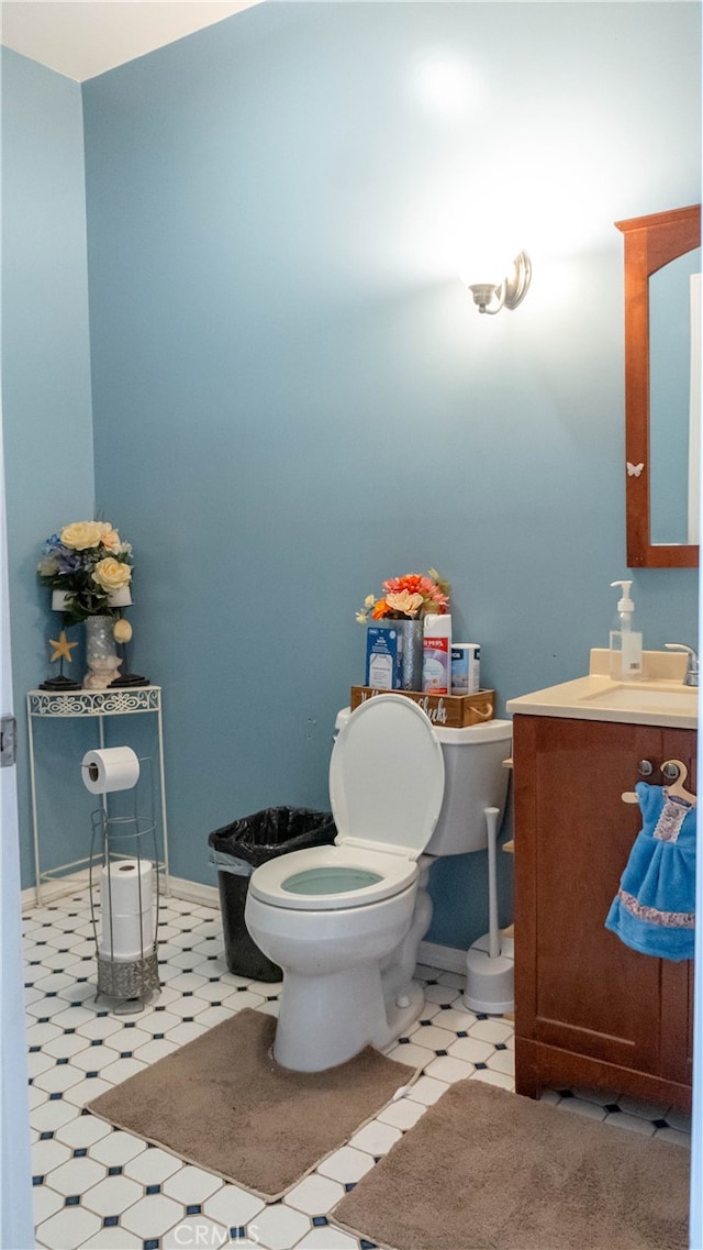 bathroom featuring vanity, toilet, and tile patterned floors