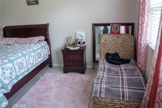 bedroom featuring light carpet