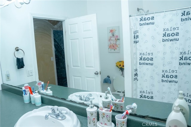 bathroom with sink and a shower with curtain