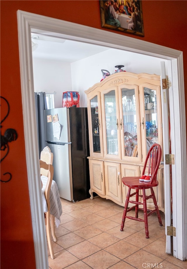 kitchen featuring stainless steel fridge and light tile patterned floors