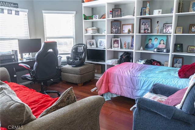 bedroom with dark hardwood / wood-style floors