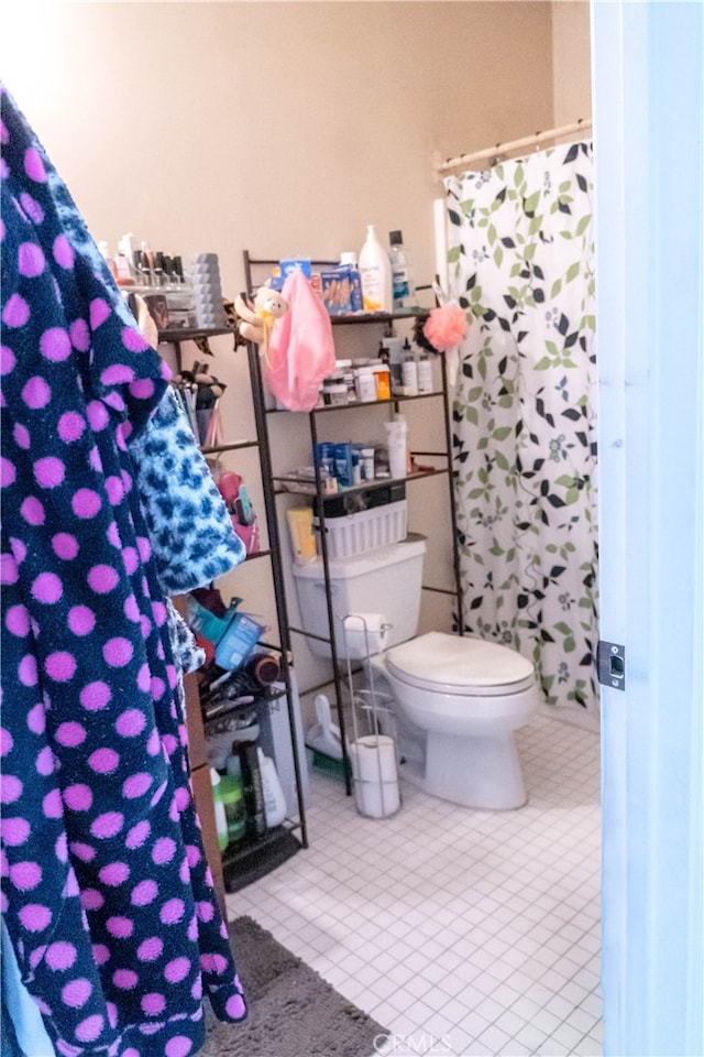 bathroom featuring tile patterned flooring and toilet