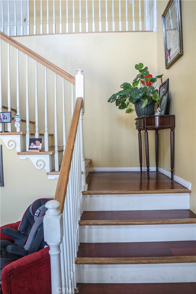 stairs featuring hardwood / wood-style flooring