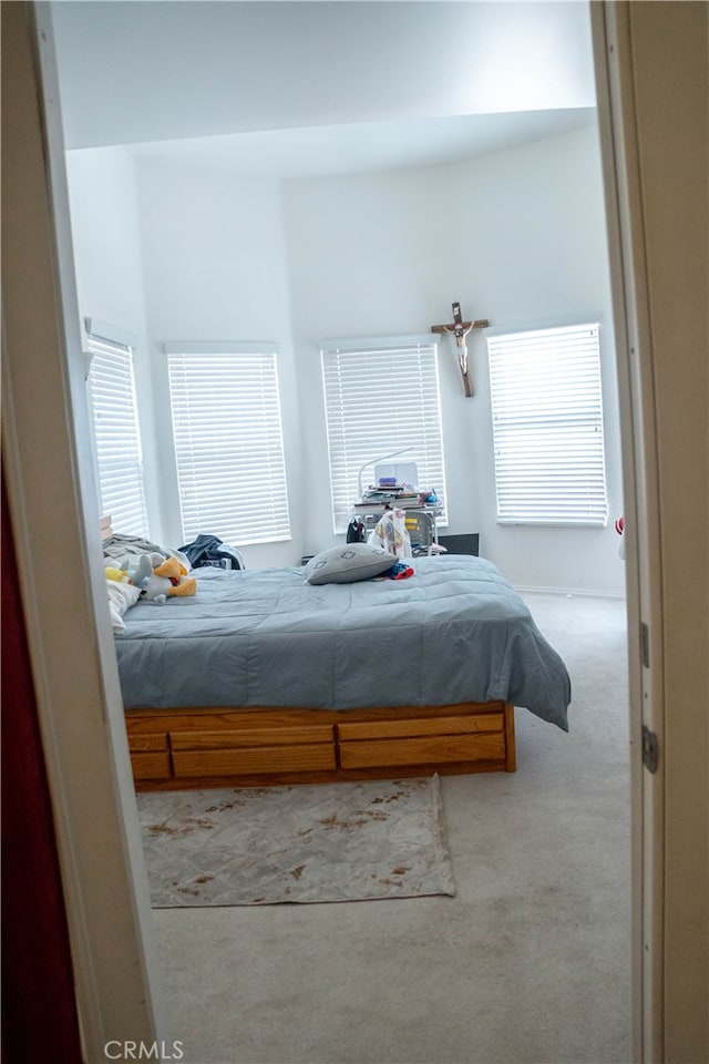 bedroom with light colored carpet