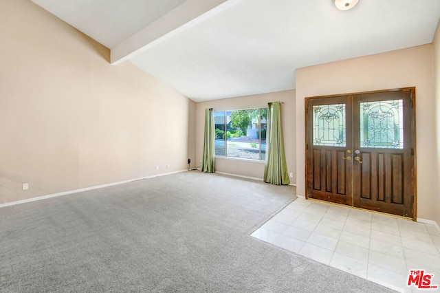 carpeted entryway featuring vaulted ceiling with beams and french doors