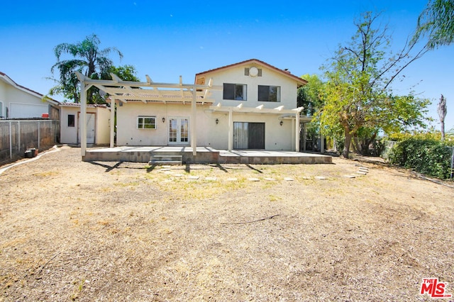 rear view of house with a pergola, a patio area, and french doors