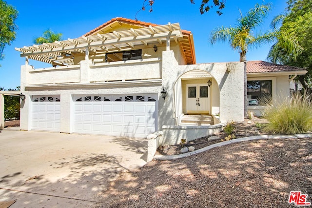 view of front facade with a balcony and a garage