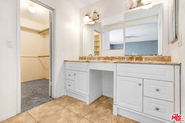 bathroom featuring tile patterned floors, vanity, and ceiling fan