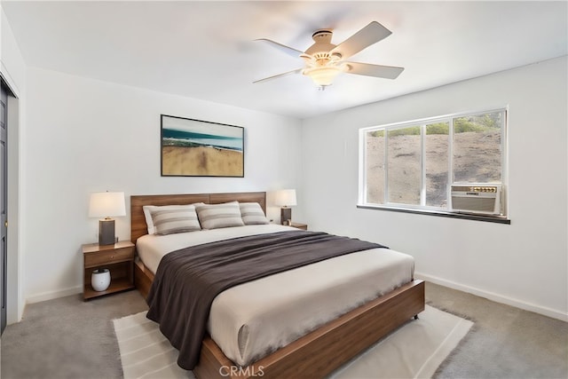 carpeted bedroom featuring cooling unit and ceiling fan