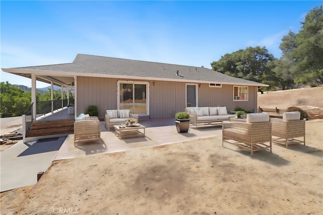 rear view of house with an outdoor living space and a patio area