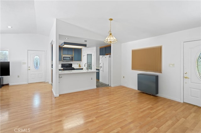 unfurnished living room featuring light wood-type flooring and vaulted ceiling