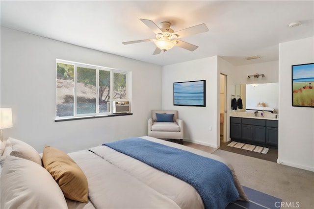 bedroom with light colored carpet, cooling unit, ceiling fan, and ensuite bathroom