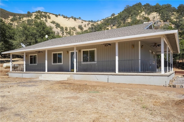 view of front facade with ceiling fan, a mountain view, and a porch