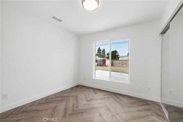 empty room with parquet flooring