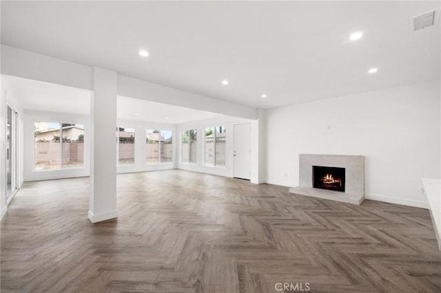 unfurnished living room with dark parquet flooring