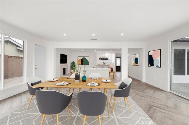 dining space featuring light parquet floors