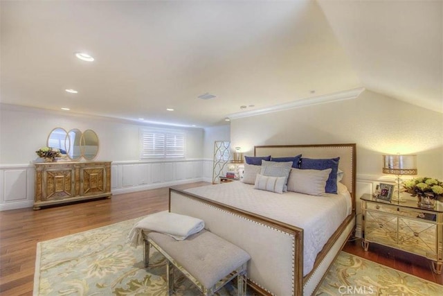 bedroom with ornamental molding and hardwood / wood-style floors