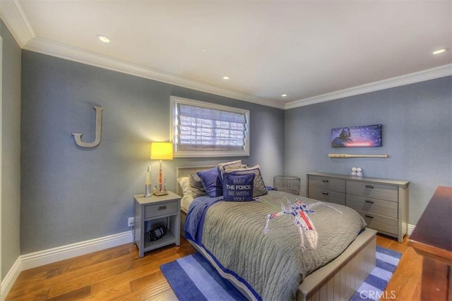 bedroom featuring light hardwood / wood-style floors and crown molding